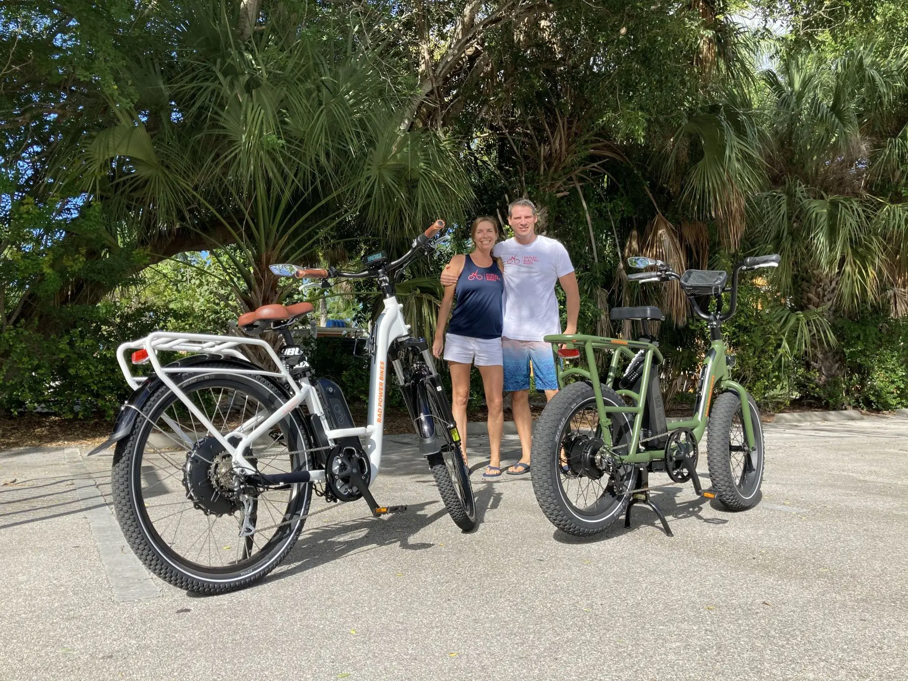 Scott and Kelly Carr standing between two Rad Power electric bikes in Naples